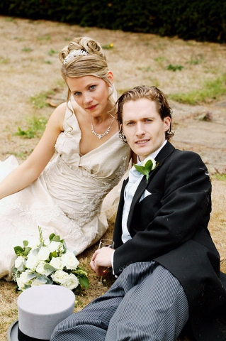 Bride and Groom have a rest on the grass during a Richmond wedding reception.