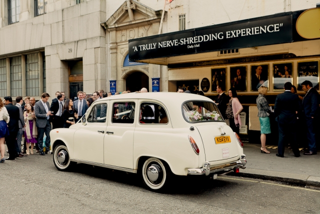 London Wedding Taxi arrives with the bride on board in Covent Garden