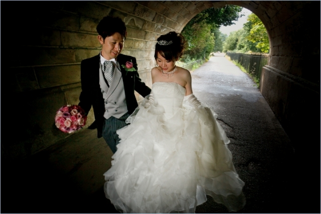 Japanese Bride and Groom walk through the tunnel of love in Hyde Park